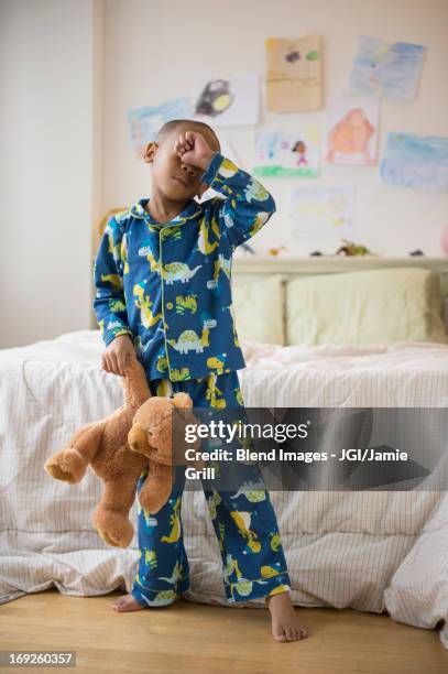 african american boy waking up in bedroom - kid rubbing eyes stock pictures, royalty-free photos & images