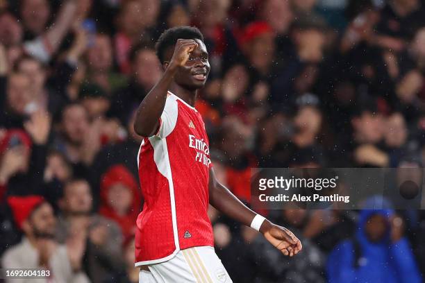 Bukayo Saka of Arsenal celebrates after scoring the team's first goal during the UEFA Champions League match between Arsenal FC and PSV Eindhoven at...