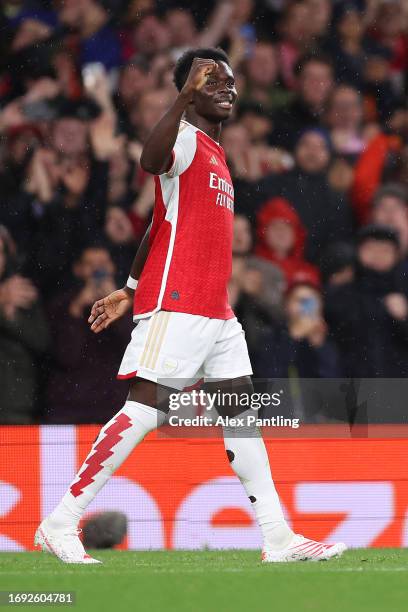 Bukayo Saka of Arsenal celebrates after scoring the team's first goal during the UEFA Champions League match between Arsenal FC and PSV Eindhoven at...
