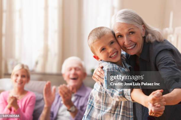 caucasian woman dancing with grandson - grandmas living room 個照片及圖片檔