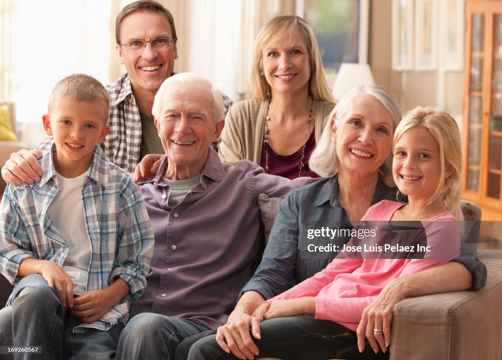 Caucasian family smiling on sofa