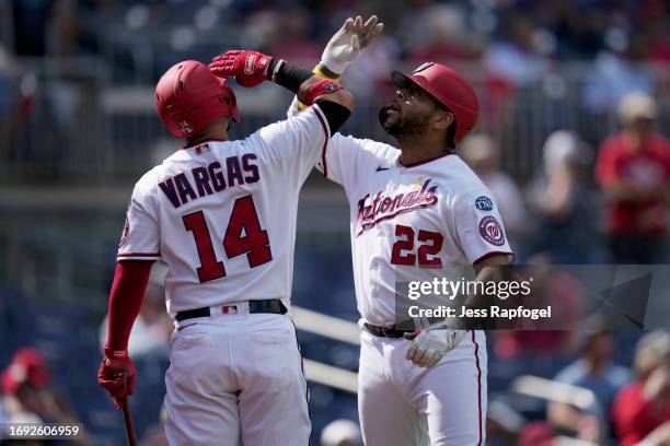 Dominic Smith of the Washington Nationals celebrates with Ildemaro Vargas after hitting a home run against the Chicago White Sox during the fourth...