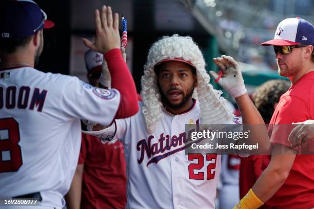 Dominic Smith of the Washington Nationals celebrates with teammates in the dugout after hitting a home run against the Chicago White Sox during the...