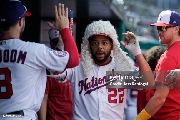Dominic Smith of the Washington Nationals celebrates with teammates in the dugout after hitting a home run against the Chicago White Sox during the...