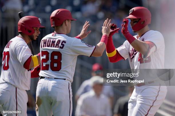 Joey Meneses of the Washington Nationals celebrates with Keibert Ruiz and Lane Thomas after hitting a two run home run against the Chicago White Sox...