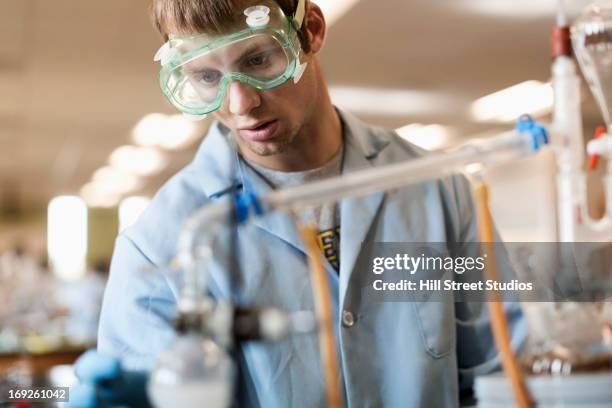 caucasian student working in chemistry lab - lab closeups stock-fotos und bilder