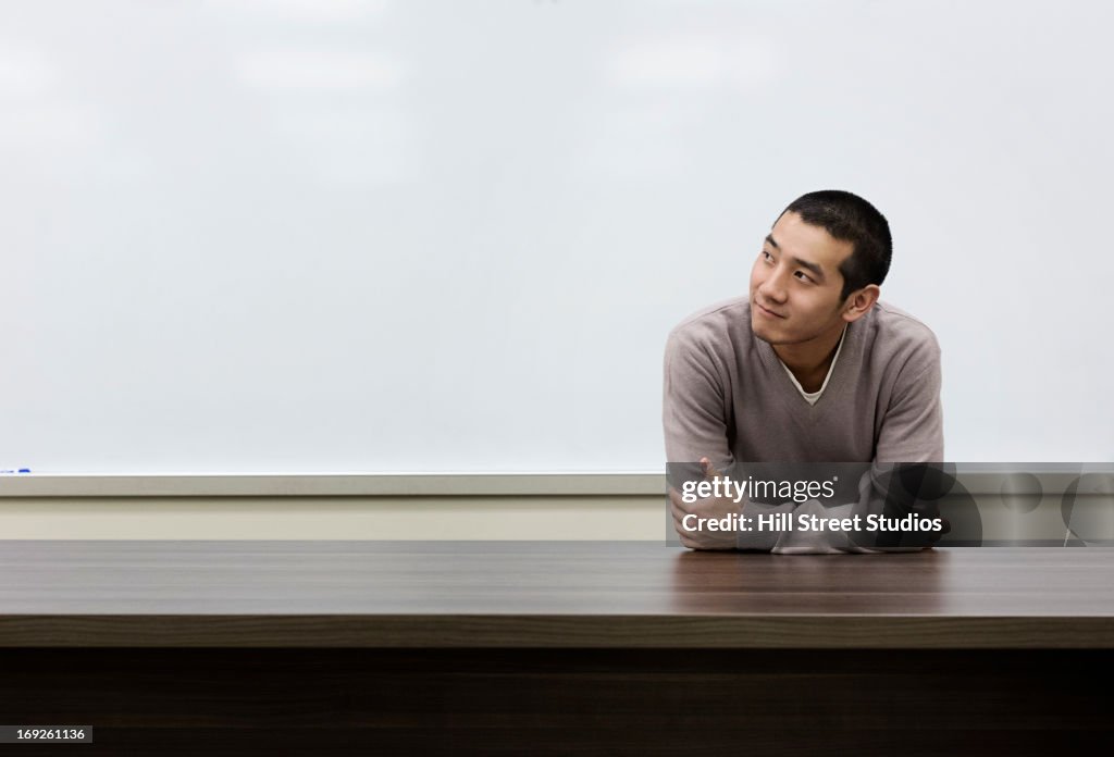 Chinese student standing at whiteboard in classroom