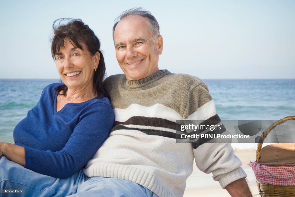 Couple relaxing at picnic on beach