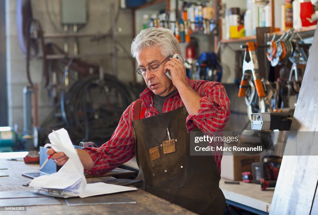 Hispanic craftsman working in shop