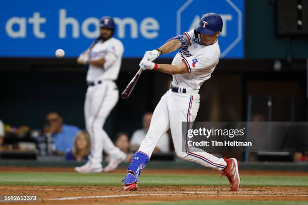 Evan Carter of the Texas Rangers hits a double in the second inning against the Boston Red Sox at Globe Life Field on September 20, 2023 in...