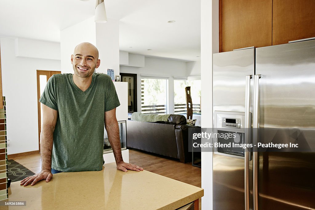 Hispanic man standing in kitchen