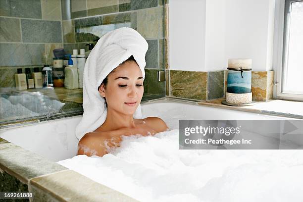 mixed race woman having bubble bath - beautiful hair at home stock pictures, royalty-free photos & images