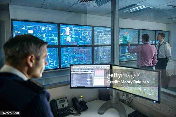 tutor at computer monitors watching students in ship's engine room simulator - technische zeichnung anschauen stock-fotos und bilder