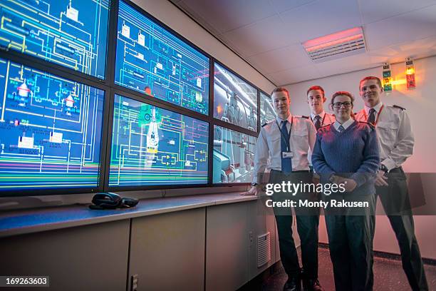 portrait of students in front of monitors in ship's engine room simulator - boat captain stock pictures, royalty-free photos & images