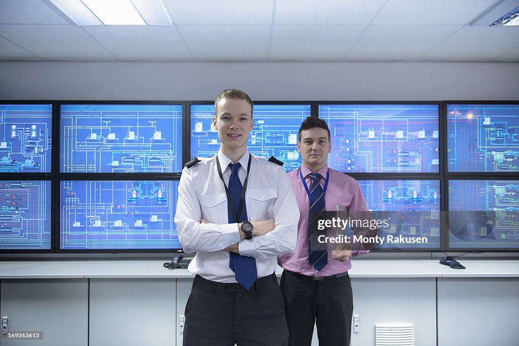 Portrait of student and tutor in ship's engine room simulator