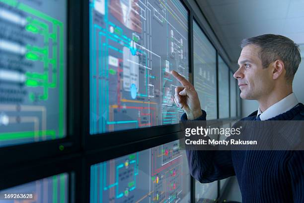 student operating equipment in ship's engine room simulator - control stock pictures, royalty-free photos & images