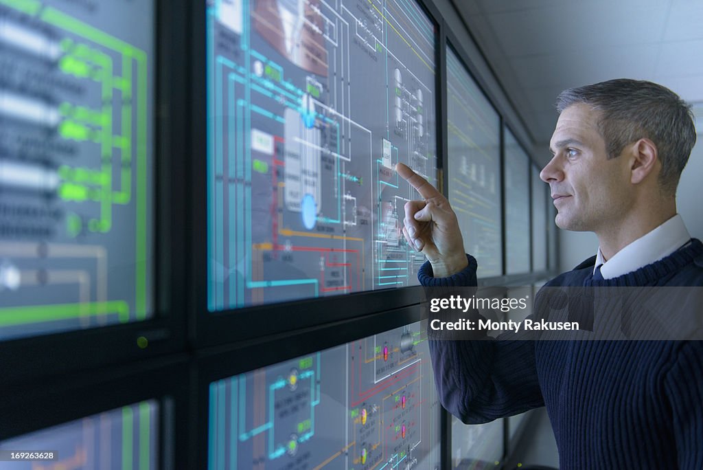 Student operating equipment in ship's engine room simulator