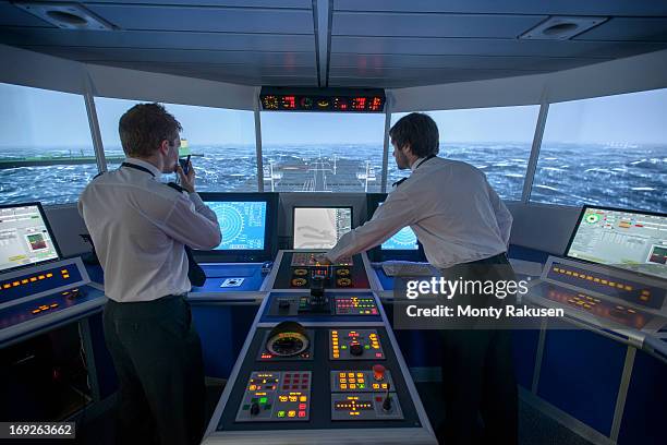 students operating equipment in ship's bridge simulation room - ship's bridge foto e immagini stock