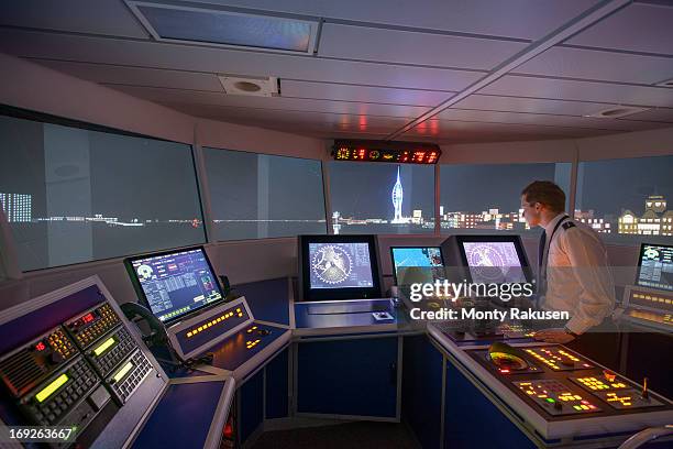 student working in ship's bridge simulation room during night scene - boat crew stock pictures, royalty-free photos & images