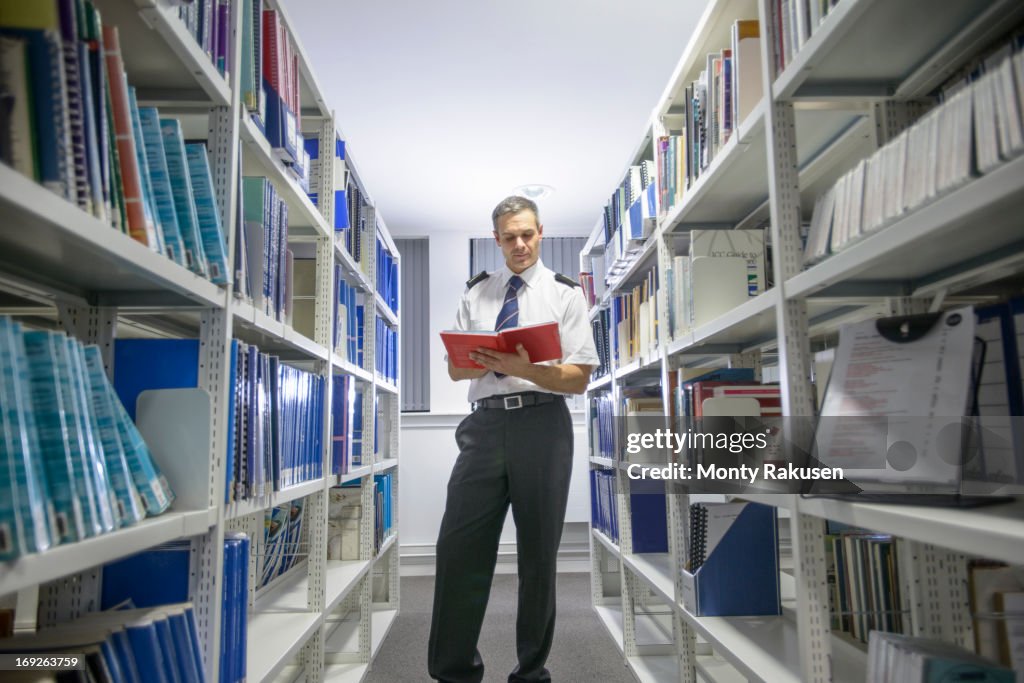 Nautical student reading textbook in library