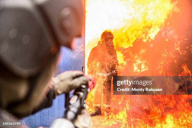 firefighters in fire simulation  training facility - firefighter uk stock pictures, royalty-free photos & images