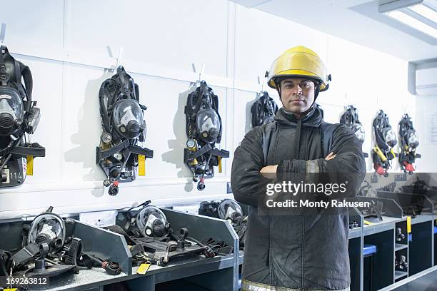 portrait of firefighter in respirator storage room of fire simulation training facility - fireman uk stock pictures, royalty-free photos & images