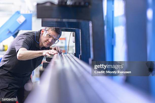 engineer wearing safety glasses and inspecting steel rods - engineer stock pictures, royalty-free photos & images