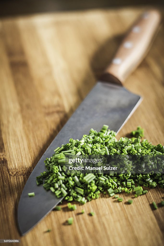 Close up of knife and chopped chives