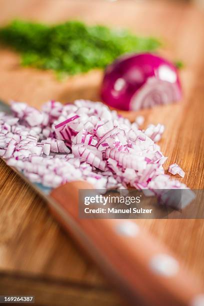 close up of knife and chopped onions - chopped stock pictures, royalty-free photos & images