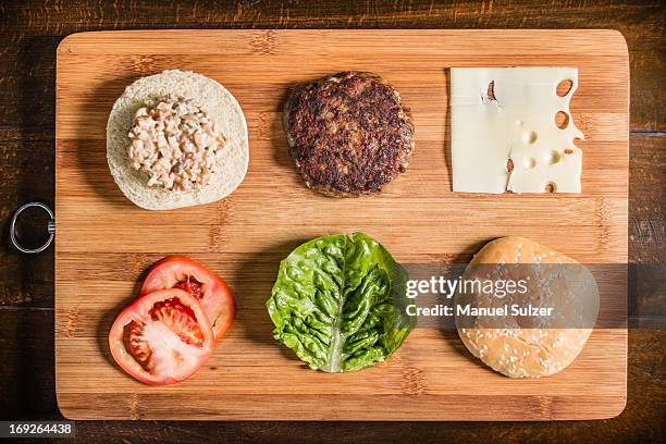 table with hamburger and condiments - burger overhead stock-fotos und bilder