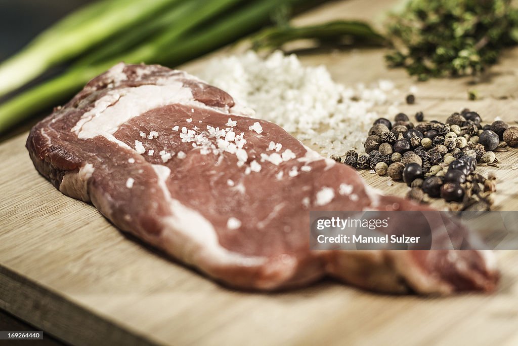 Close up of seasoned meat on board