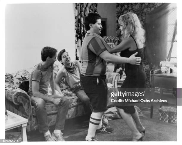 Steve Antin and Lawrence Monoson sharing a laugh as Joe Rubbo dances with Louisa Moritz in a scene from the film 'The Last American Virgin', 1982.