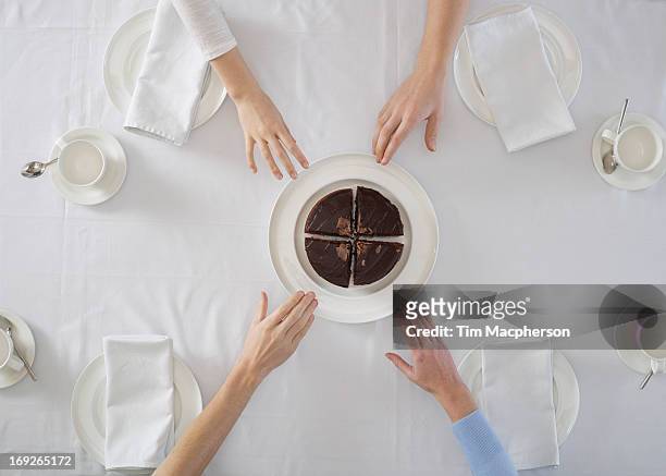 overhead view of people sharing dessert - chocolate cake above fotografías e imágenes de stock