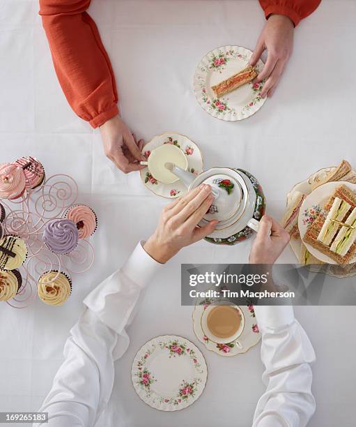 overhead view of people having tea - cup of tea from above stock pictures, royalty-free photos & images