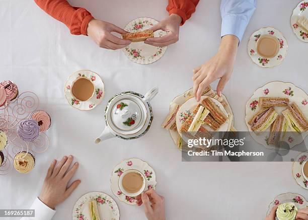 overhead view of people having tea - cup of tea from above stock pictures, royalty-free photos & images