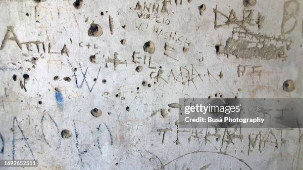 wall with carved words and texts - alphabet hand made stock-fotos und bilder