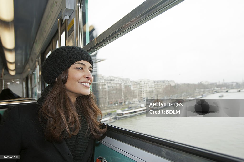 Smiling woman riding train over water