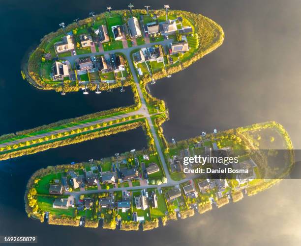 aerial photo of climate-neutral new residential areas on landscaped peninsulas in the netherlands - groningen city stock-fotos und bilder