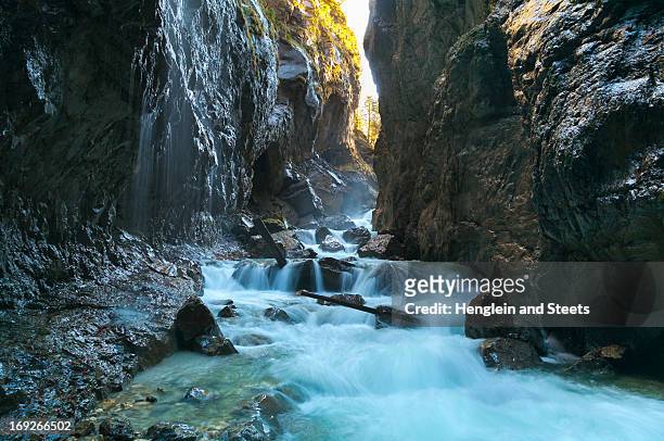 river rushing through rocky canyon - partnach gorge stock pictures, royalty-free photos & images