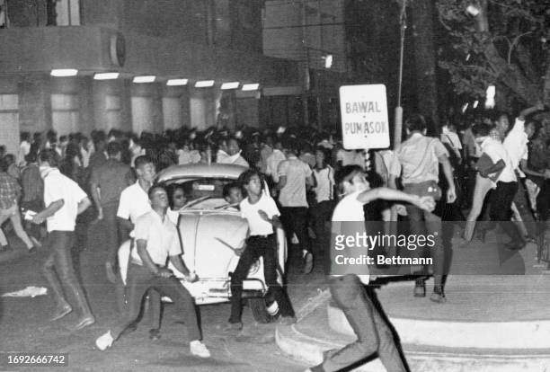 Throwing stones and Molotov cocktails, youthful anti-American demonstrators battle police in front of the U.S. Embassy.