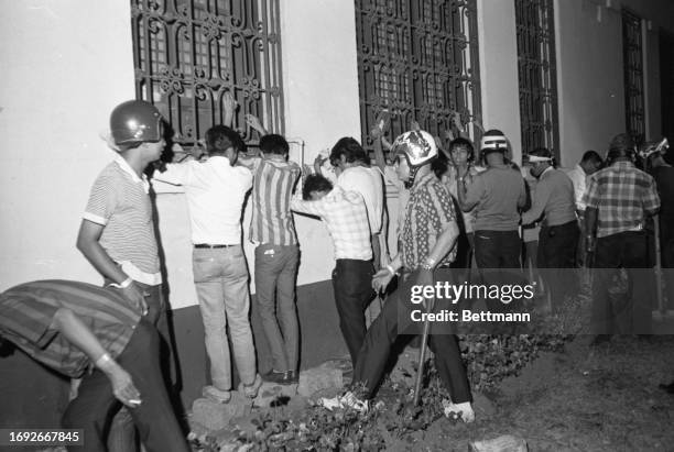 Filipino soldiers frisk student demonstrators in the wake of a march on the American Embassy. Troops turned back about 2,000 snake-dancing students...