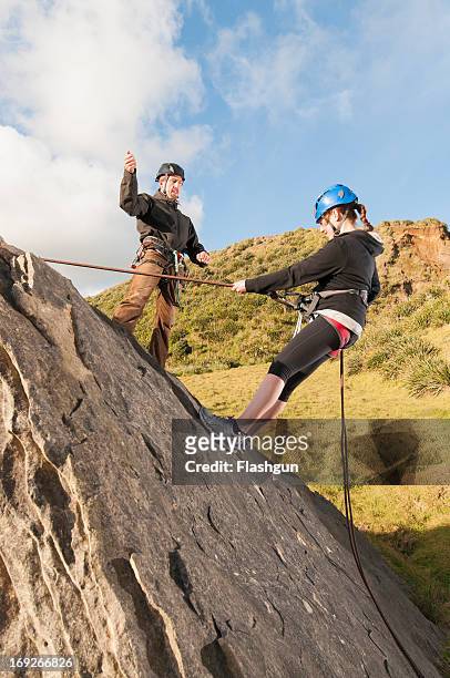 people abseiling in rock climbing lesson - raglan nya zeeland bildbanksfoton och bilder