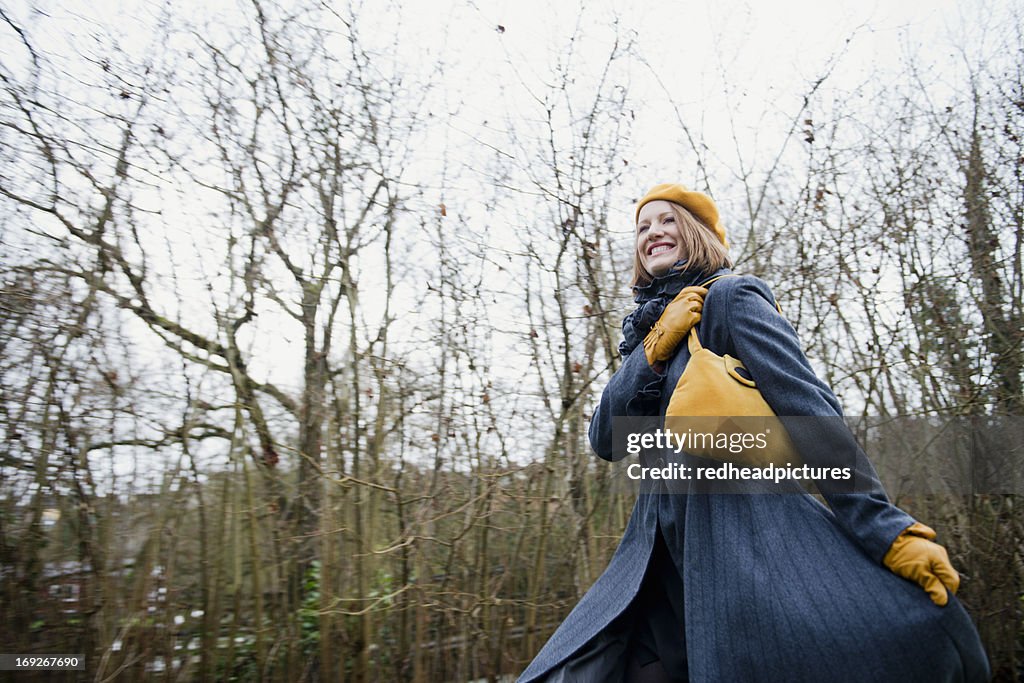 Smiling woman walking in forest
