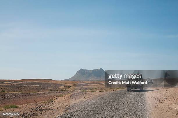jeeps driving in dusty landscape - isla de boa vista fotografías e imágenes de stock
