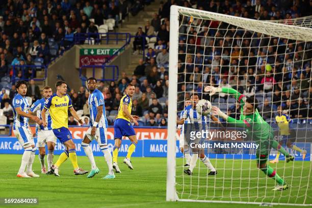 Ben Wilmot of Stoke City scores the team's second goal past Lee Nicholls of Huddersfield Town during the Sky Bet Championship match between...