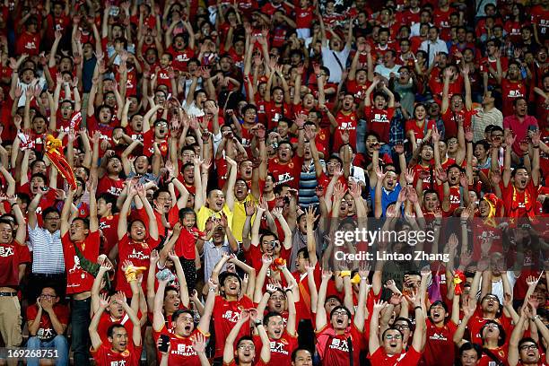 Evergrande fans celebrate a goal during the AFC Champions League knockout round match between Guangzhou Evergrande and Central Coast Mariners at...