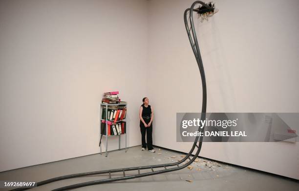 Gallery assistant poses next to installations by artist Jesse Darling entitled 'Big Dipper' and "Epistemologies" during a photocall for the Turner...