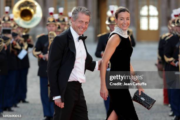 Hugh Grant and Anna Elisabet Eberstein arrive ahead of a state dinner at the Chateau de Versailles on September 20, 2023 in Versailles, France. The...