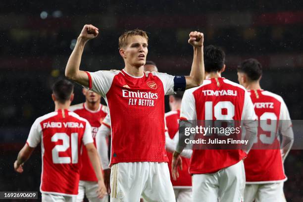 Martin Oedegaard of Arsenal celebrates after scoring the team's fourth goal during the UEFA Champions League match between Arsenal FC and PSV...