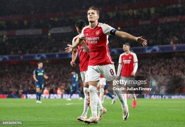 Martin Oedegaard of Arsenal celebrates after scoring the team's fourth goal during the UEFA Champions League match between Arsenal FC and PSV...